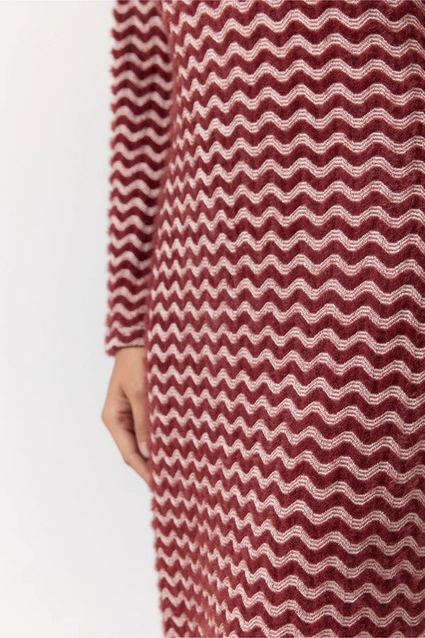 Maroon and white patterned dress on a plain background