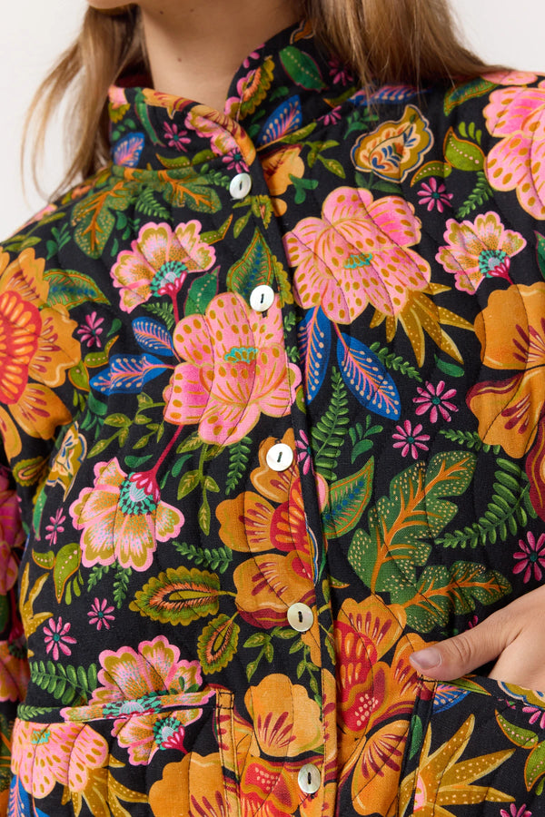 Close-up of a colorful floral patterned shirt with a person wearing it.