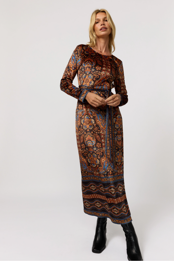 Woman wearing a patterned dress on a white background