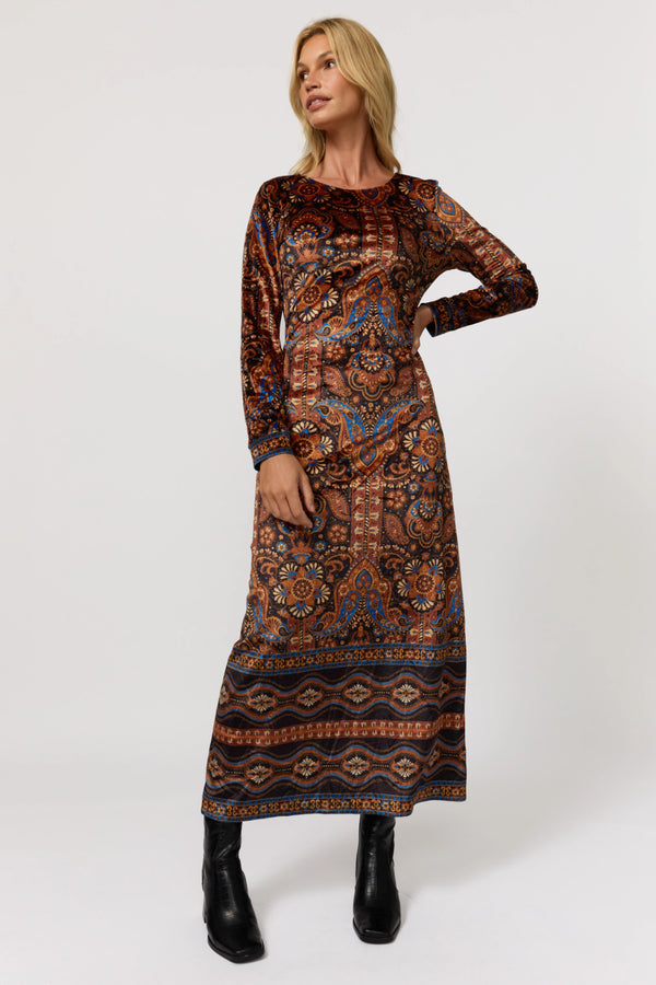 Woman wearing a patterned dress on a white background
