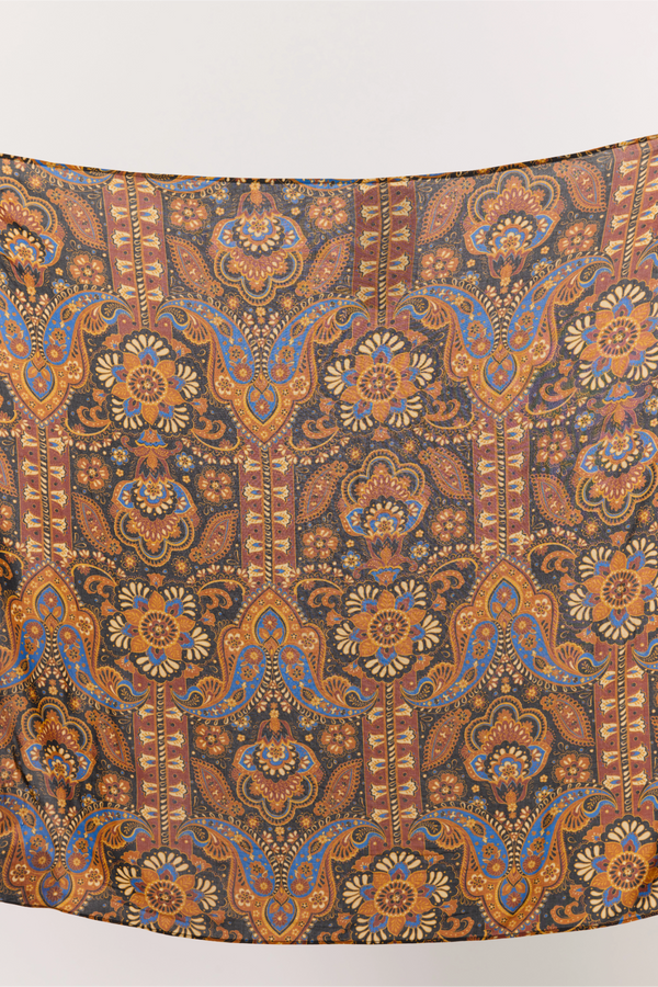 Decorative fabric with intricate paisley pattern on a white background