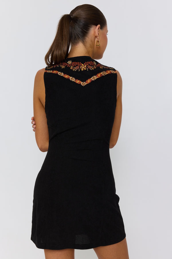 Black dress with floral embroidery on a white background