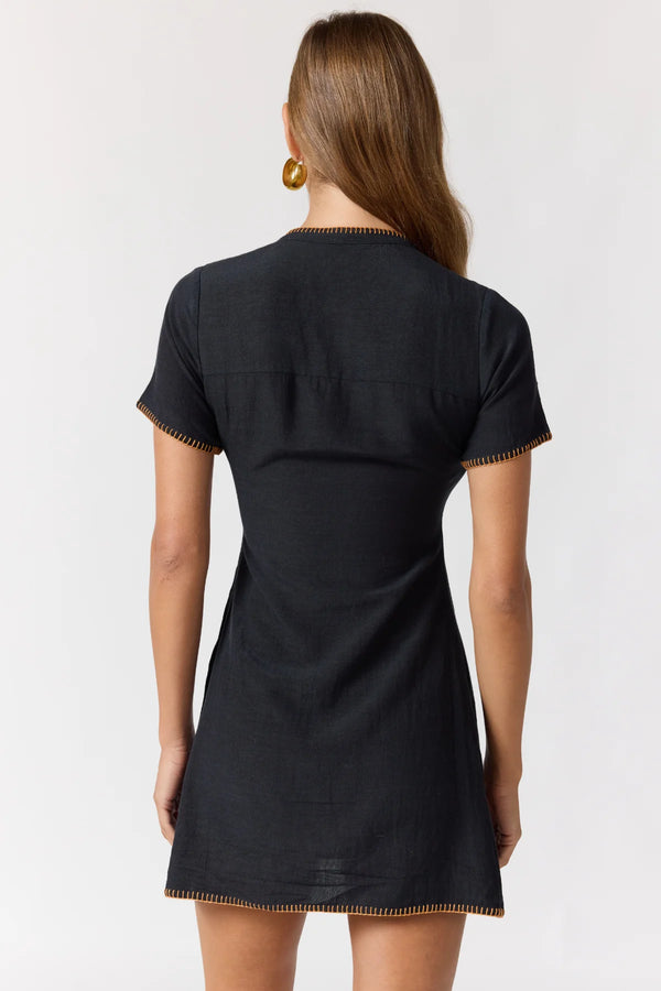 Black dress with gold trim on a white background