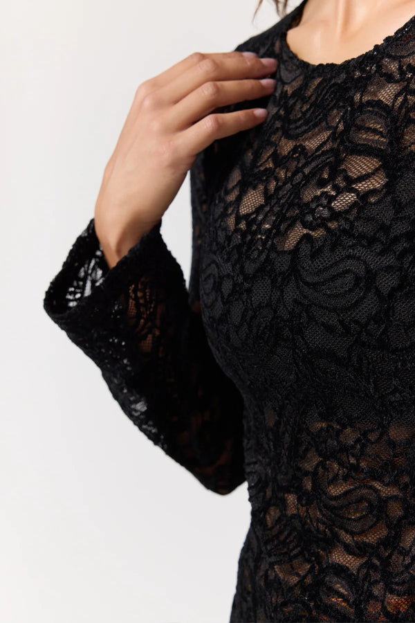 Black lace garment with a white background