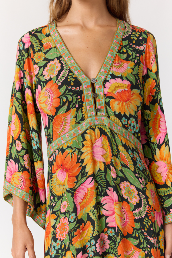 Colorful floral dress with a deep neckline and long sleeves on a white background