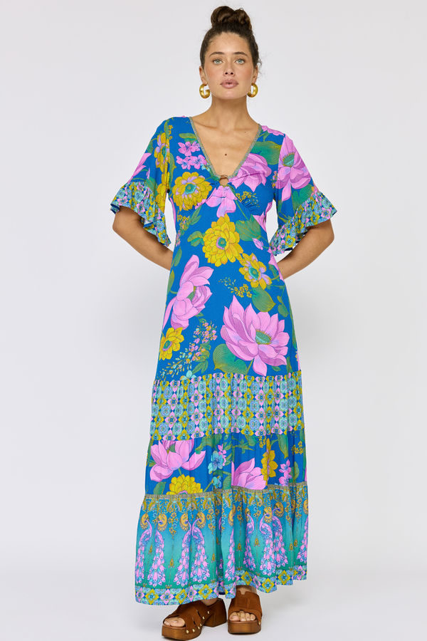 Woman wearing a colorful floral dress on a white background