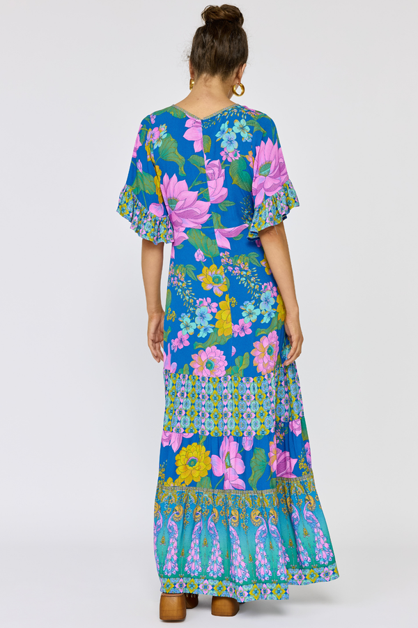 Woman wearing a colorful floral dress on a white background