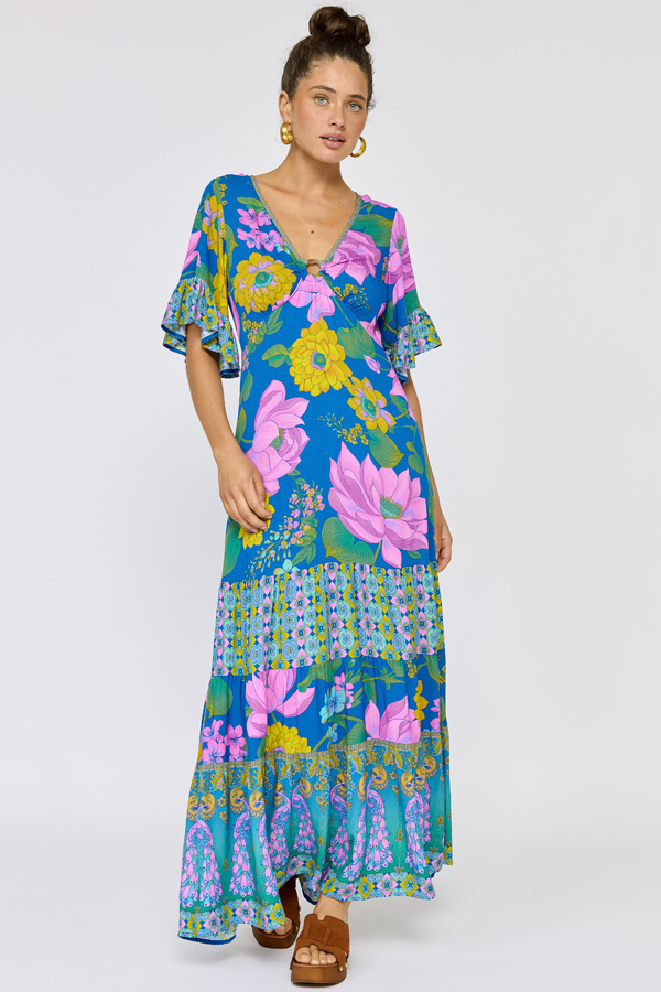 Woman wearing a colorful floral dress on a white background