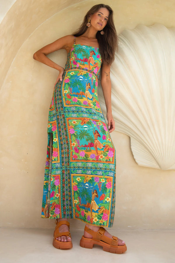 Woman wearing a colorful dress with floral patterns against a neutral background