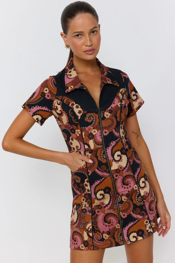 Woman wearing a patterned dress on a white background