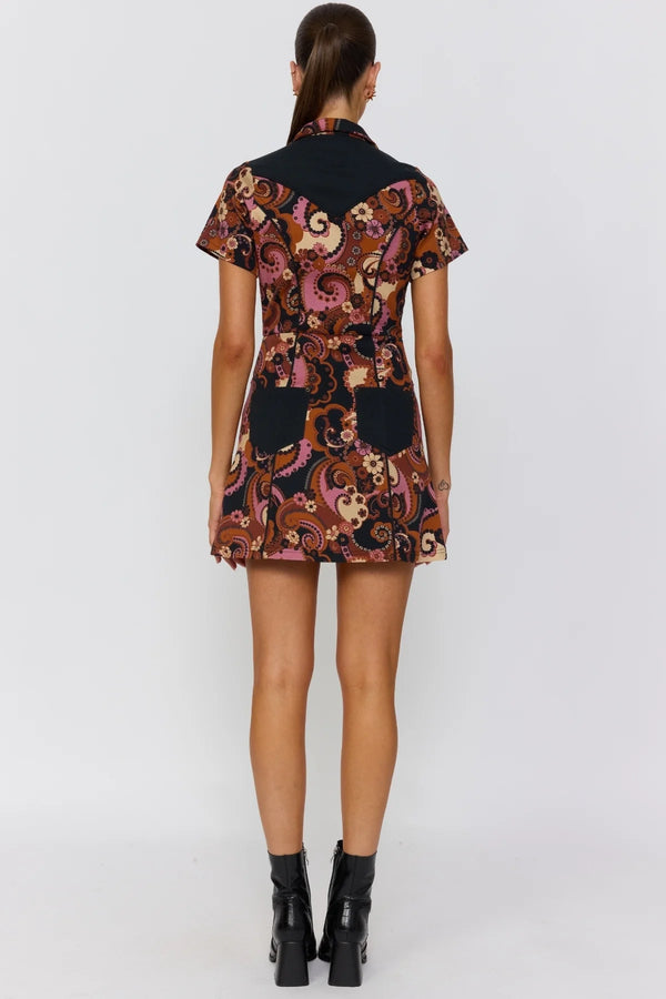 Woman wearing a patterned dress on a white background
