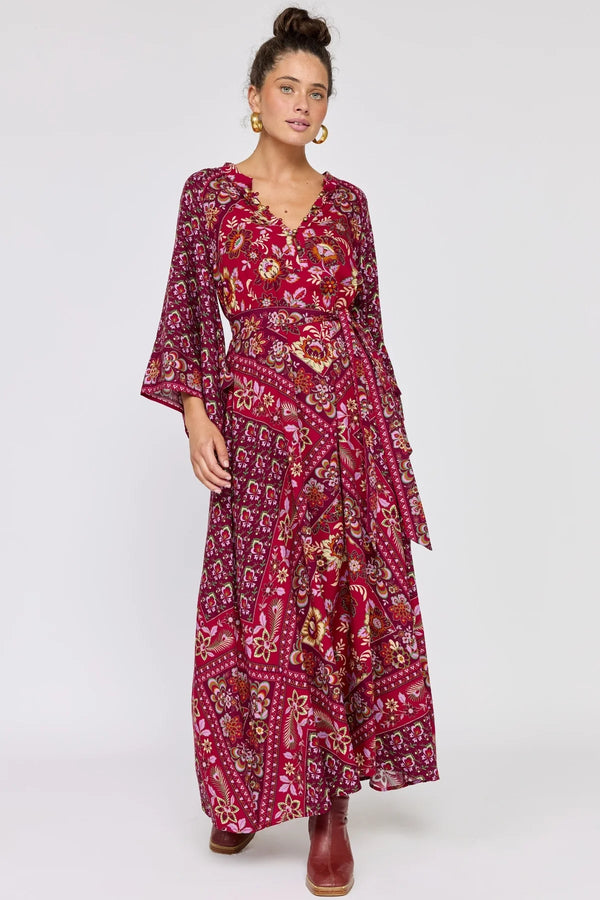 Woman wearing a red patterned dress on a white background