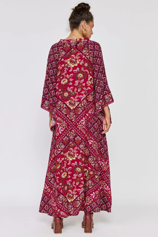 Woman wearing a red floral dress on a white background