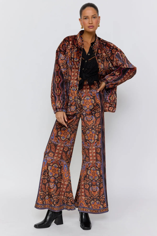 Woman wearing a patterned outfit on a white background