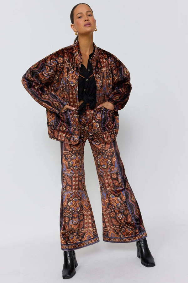 Person wearing a patterned outfit on a white background