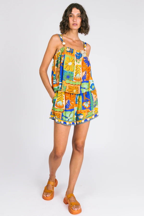 Woman wearing a colorful floral dress on a white background