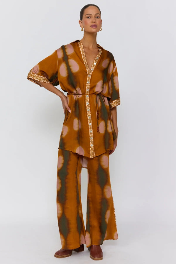 Woman wearing a patterned outfit on a white background