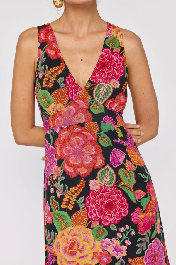 Woman wearing a colorful floral dress on a white background
