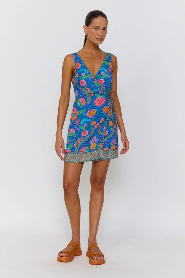 Woman wearing a colorful floral dress on a white background