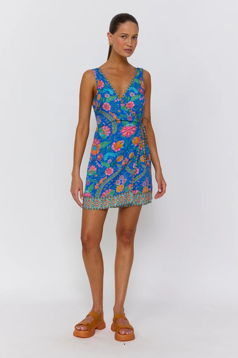 Woman wearing a colorful floral dress on a white background