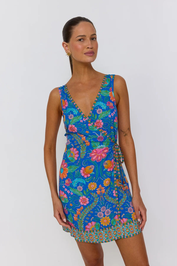 Woman wearing a colorful floral dress on a white background