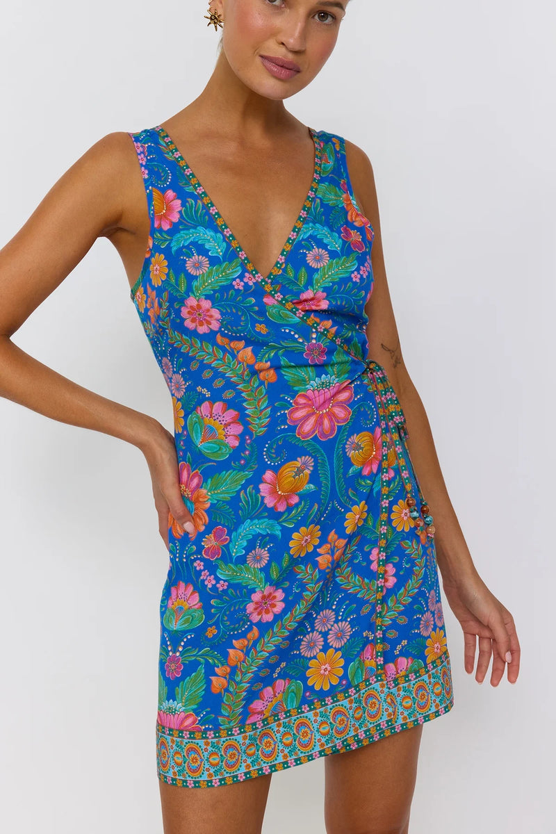 Woman wearing a colorful floral dress on a white background