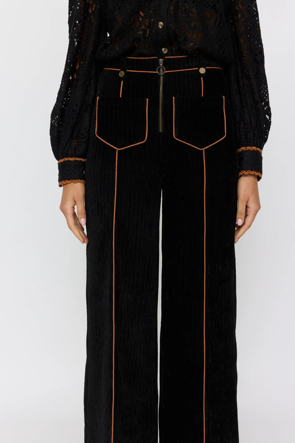 Black pants with orange stitching on a white background