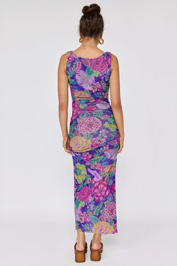 Woman wearing a colorful floral dress on a white background