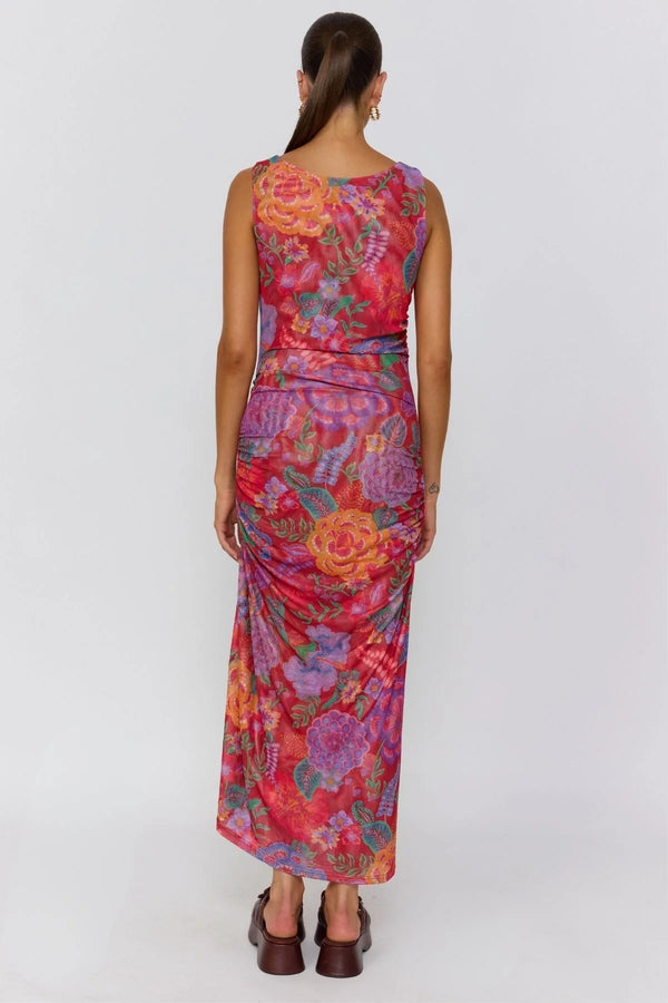 Woman wearing a colorful floral dress on a white background