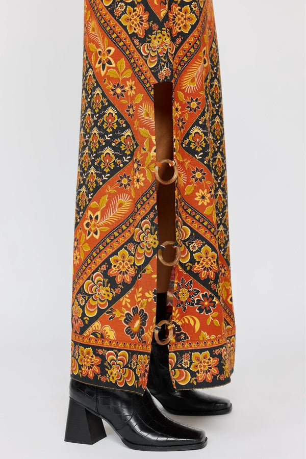 Black leather boots with a patterned orange and blue fabric background