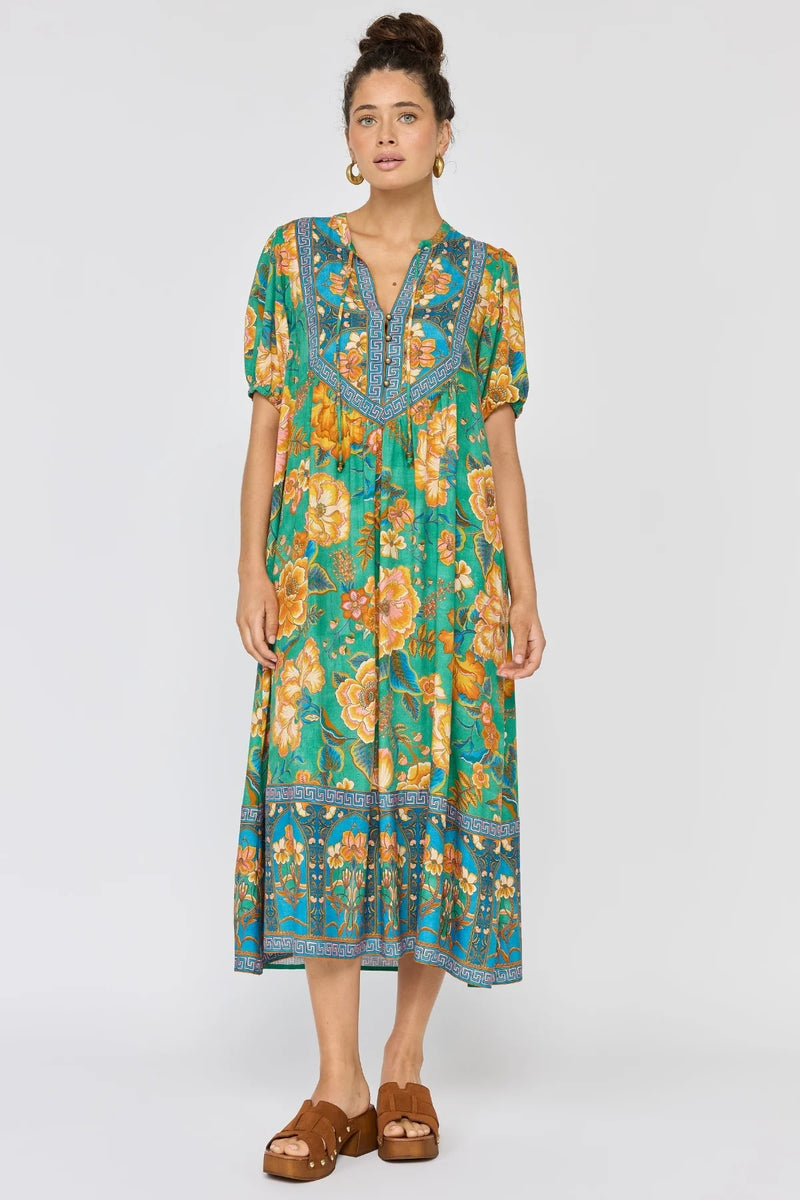 Woman wearing a colorful floral dress on a white background