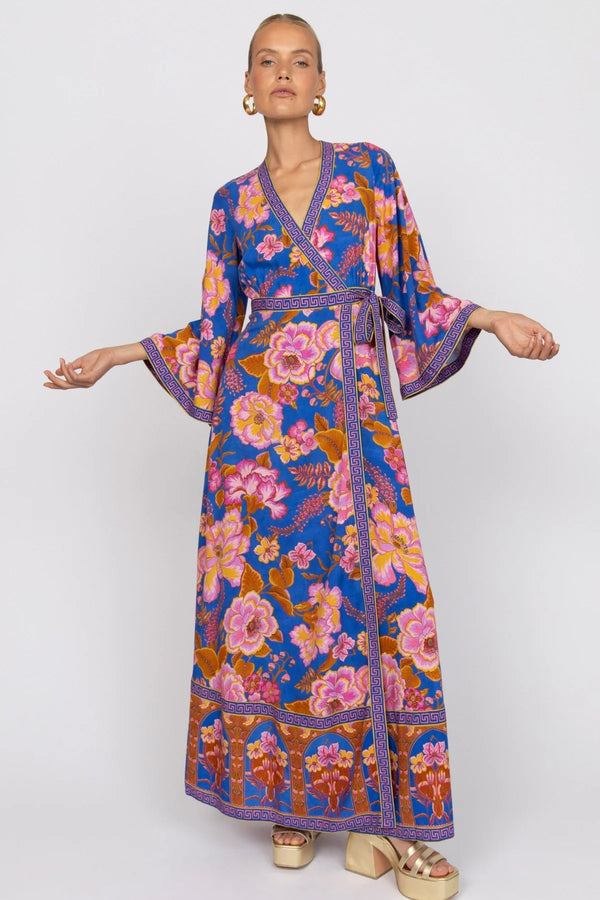 Woman wearing a colorful floral dress on a white background