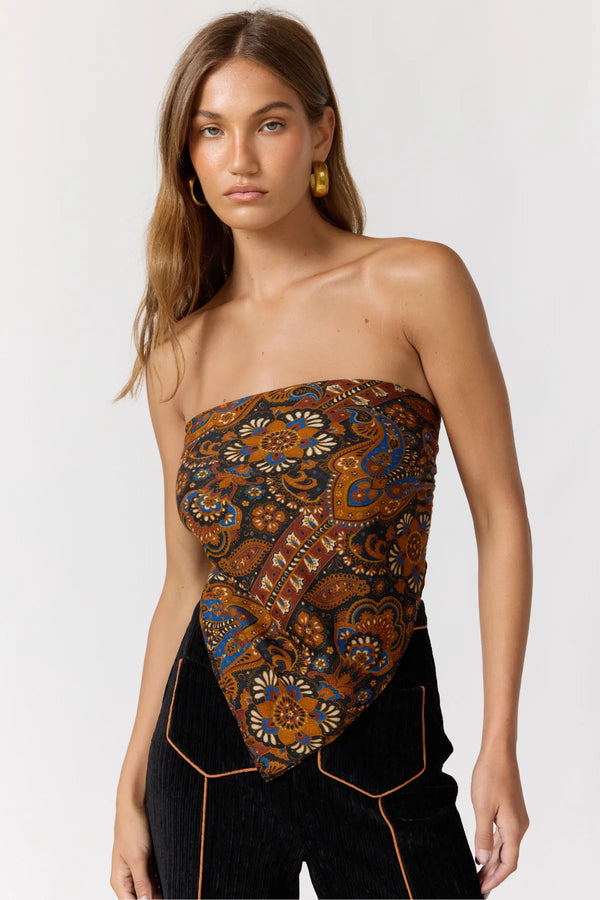 Woman wearing a strapless top with a floral pattern on a white background